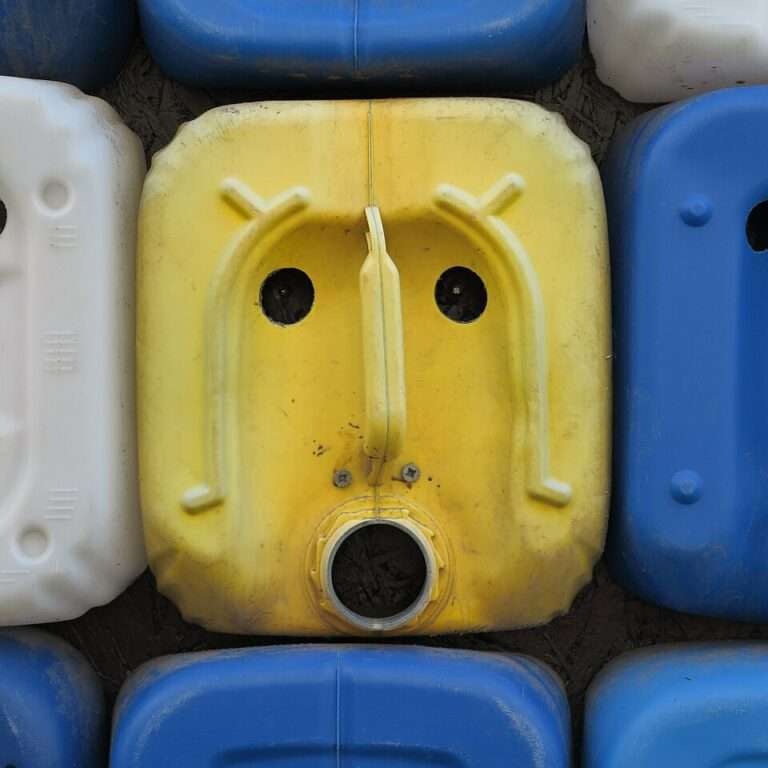 Effet de paréidolie formant un visage sur des bidons décoratifs muraux à Câmara de Lobos